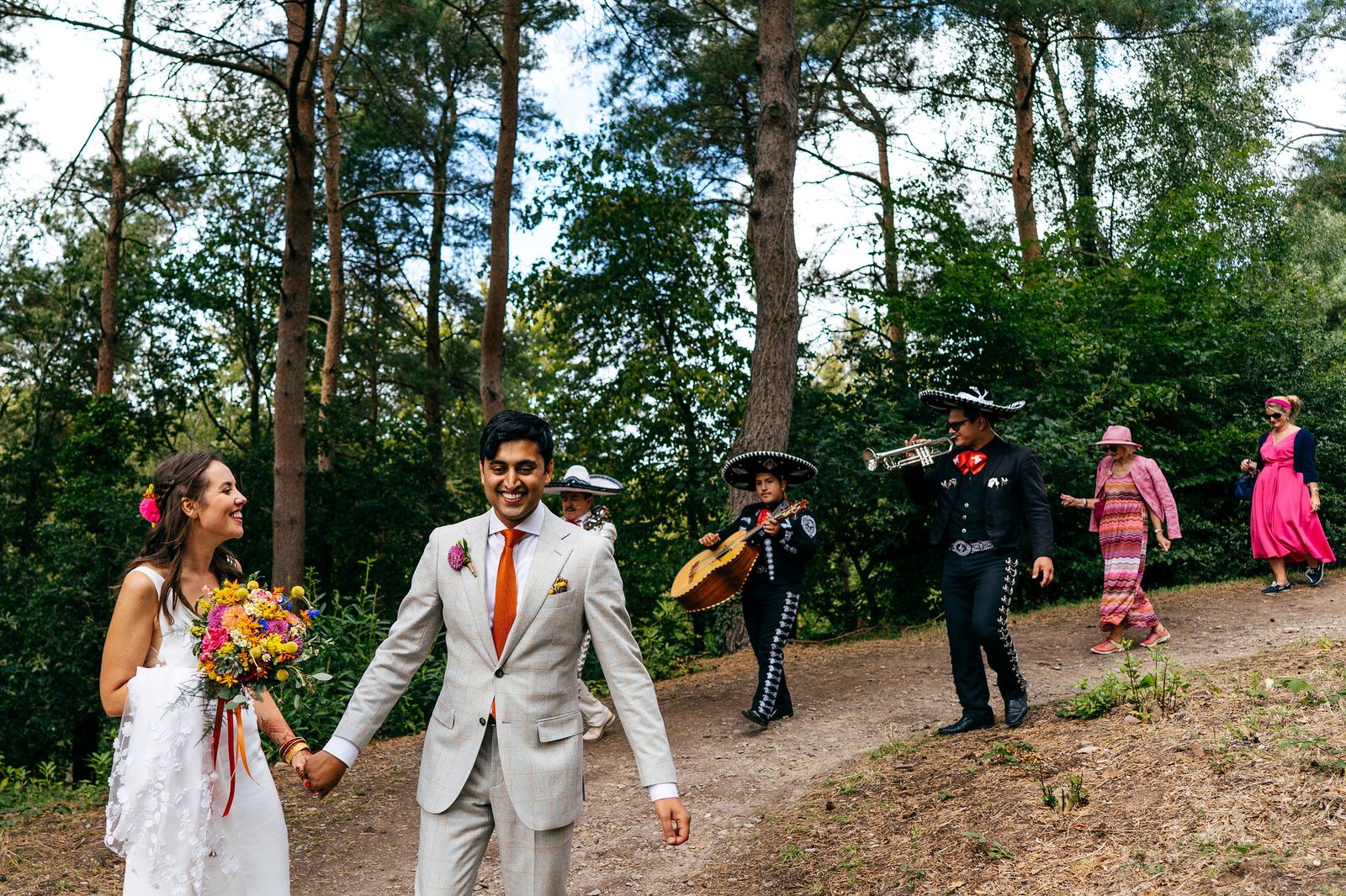 Newlyweds dance down the path at Hestercombe Gardens with musicians