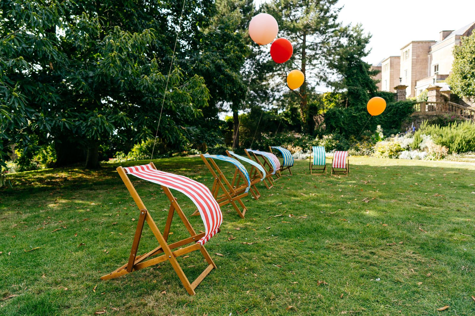 Deck chairs and balloons for outdoor entertainment at this Somerset wedding